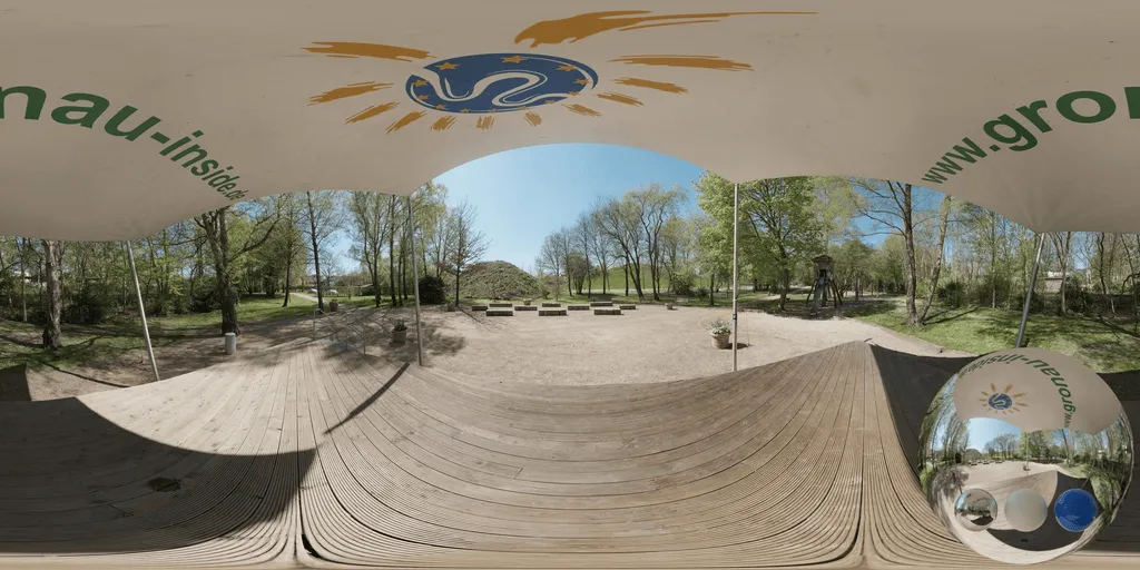 A sunny park terrace hdri showing a wooden deck under a fabric canopy, with trees, paths, and seating in bright daylight.